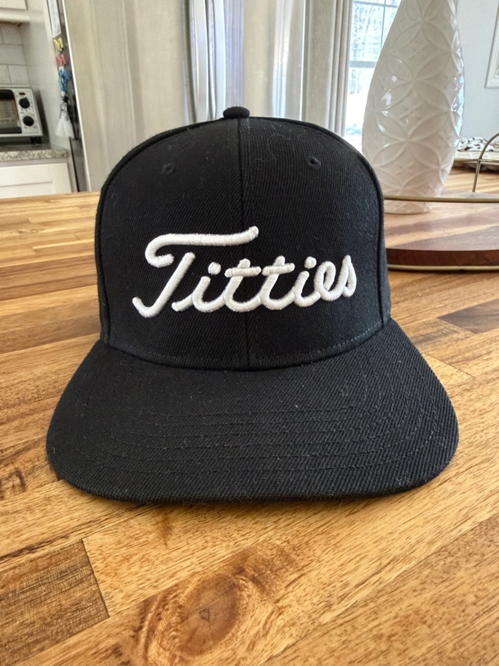 Black Snapback Hat with White Script Logo